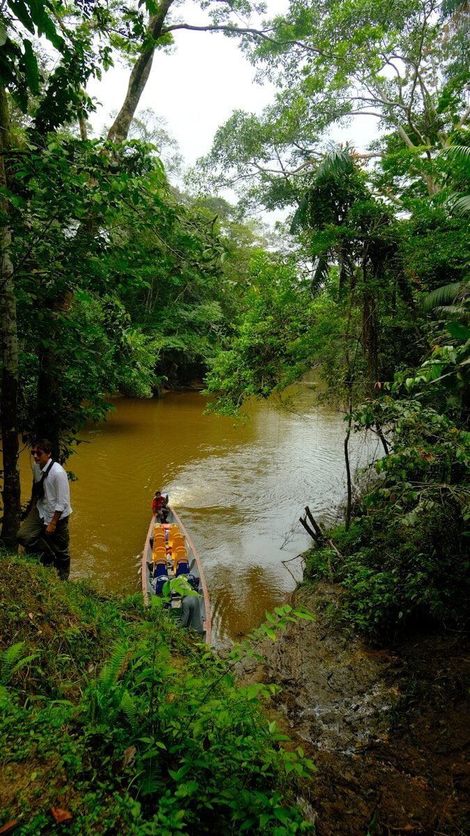 A man and a woman in a canoe on a river