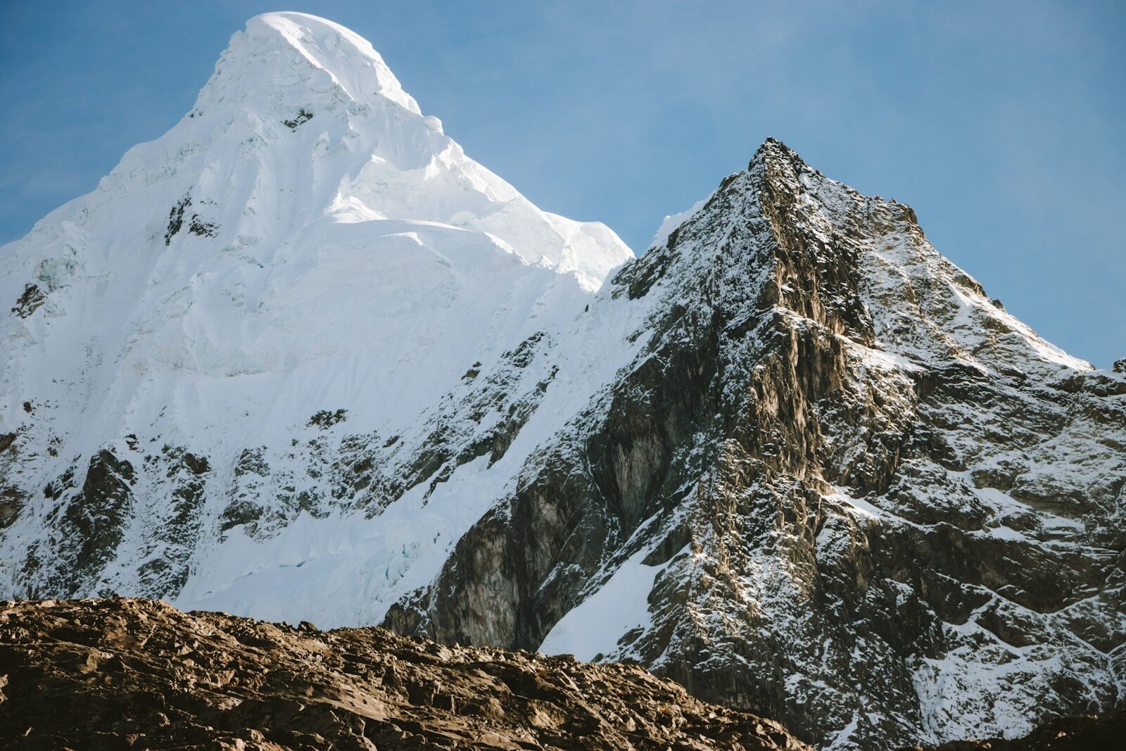 A snow covered mountain with a clear blue sky