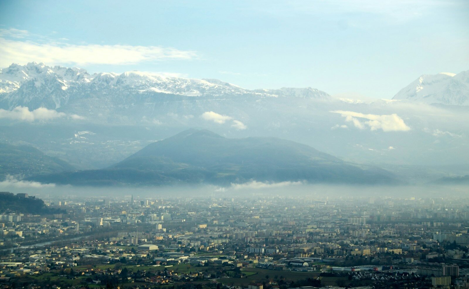 a view of a city with mountains in the background